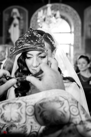 A traditional wedding ceremony moment captured in black and white with ornate decorative details.
