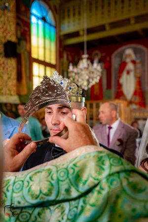 Ornate church interior with stained glass windows during a wedding ceremony.