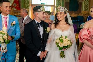 Wedding celebration captured in an ornate room with traditional decorative elements.