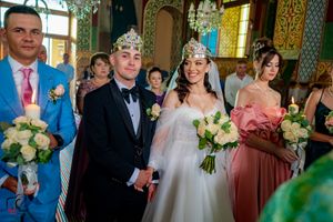 Formal wedding gathering in a richly decorated venue with vintage architectural details.