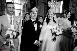 Black and white wedding photograph in a traditional ceremonial setting.