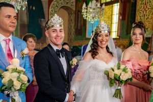 Wedding party posing in an elegant venue with classic architectural features.