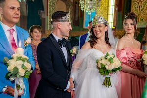 Wedding celebration with formal attire in a beautifully decorated historic venue.