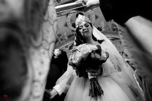 Black and white photo of a couple during their wedding ceremony with elegant decor.