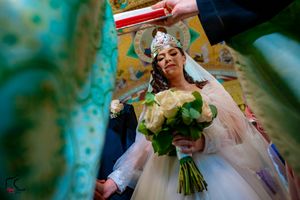 Wedding ceremony scene with vibrant teal and green tones and floral bouquet.