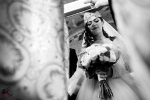 Artistic black and white wedding photo with soft focus and decorative elements.