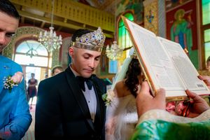 Traditional wedding ceremony in an elaborately decorated venue with golden accents.