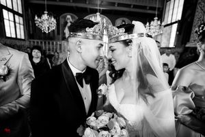 Black and white photo of a wedding ceremony in an ornate Orthodox church interior.
