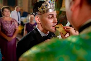 Traditional Orthodox wedding ceremony with clergy in emerald robes and ornate crowns.