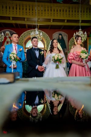 Creative double exposure of wedding party with reflections in Orthodox church setting.