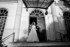 Black and white architectural photo of church entrance with dramatic shadows.
