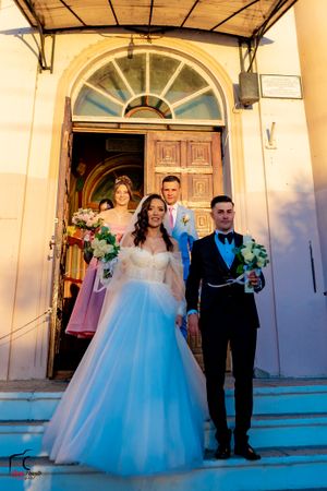Wedding ceremony exit at a historic church with beautiful architectural details.