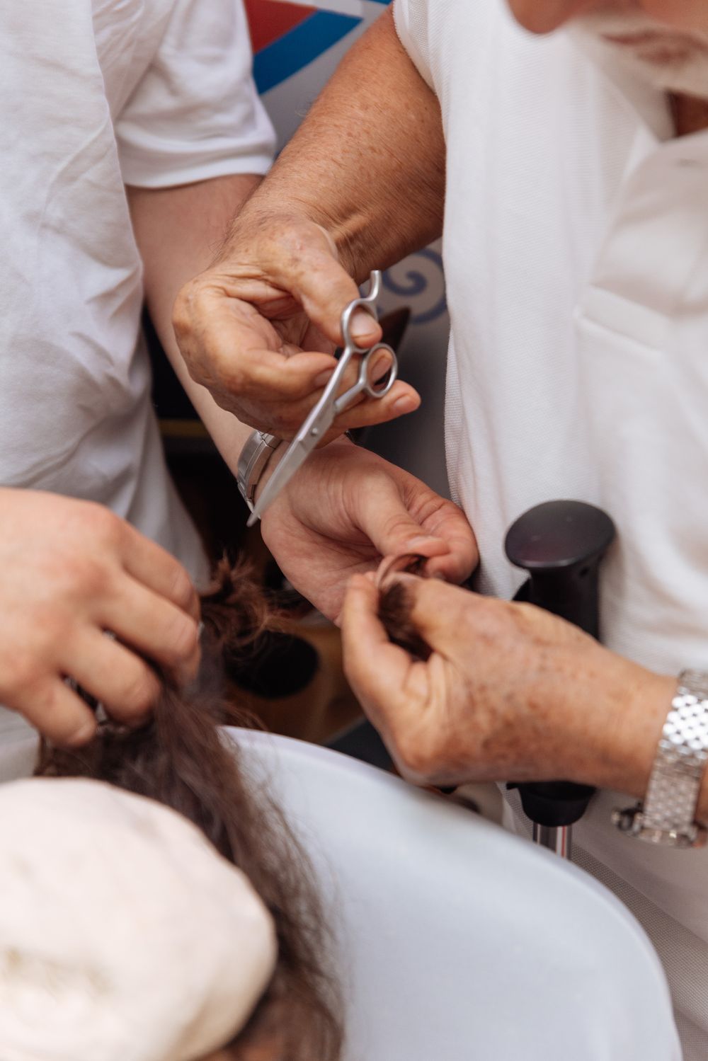 Close-up view of dental professionals using tools during a dental procedure in a clinic.