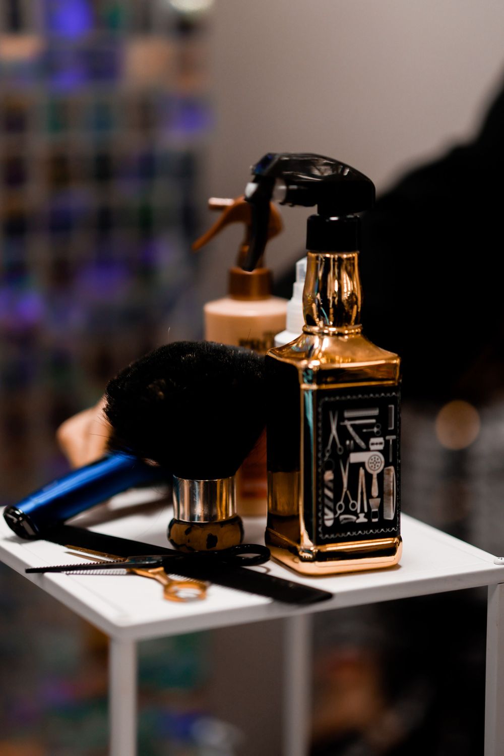 Professional barber supplies including spray bottle and tools on sleek modern counter after the ceremony of first haircut