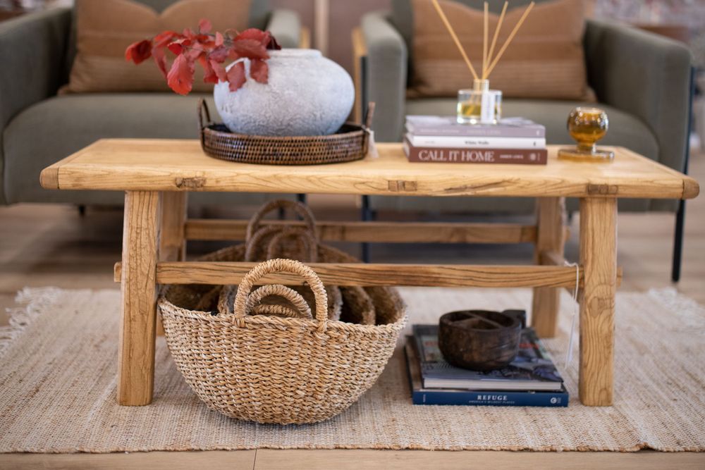 Modern farmhouse living room featuring rustic wood coffee tables and cozy decor accents.