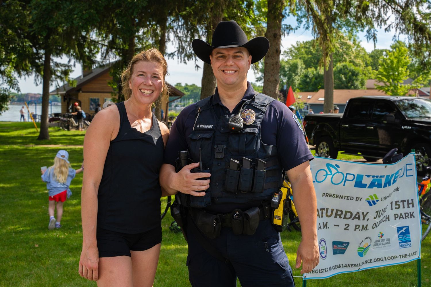 Summer festival scene with vendor booth and trees in background.