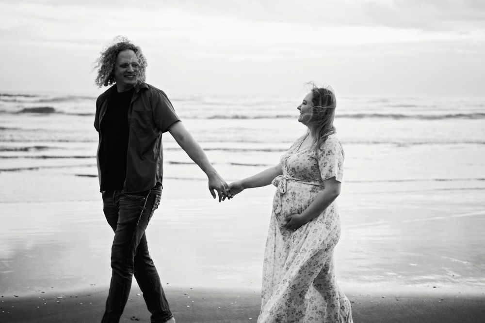 walking on the beach in black and white