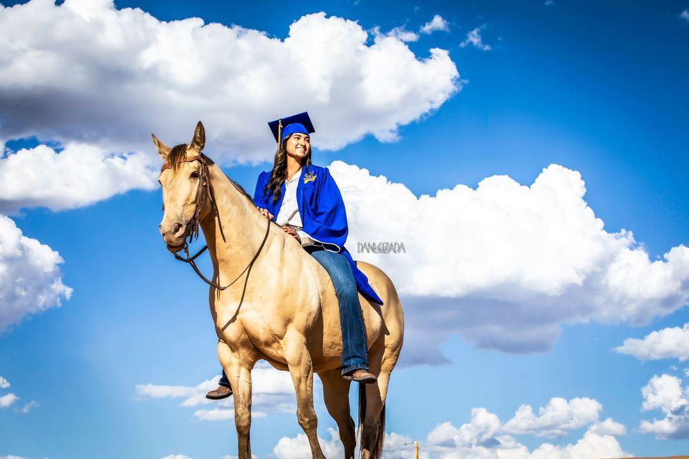 Senior portraits in El Paso – Class of 2025 graduate riding a horse at Red Sands with a bold desert backdrop