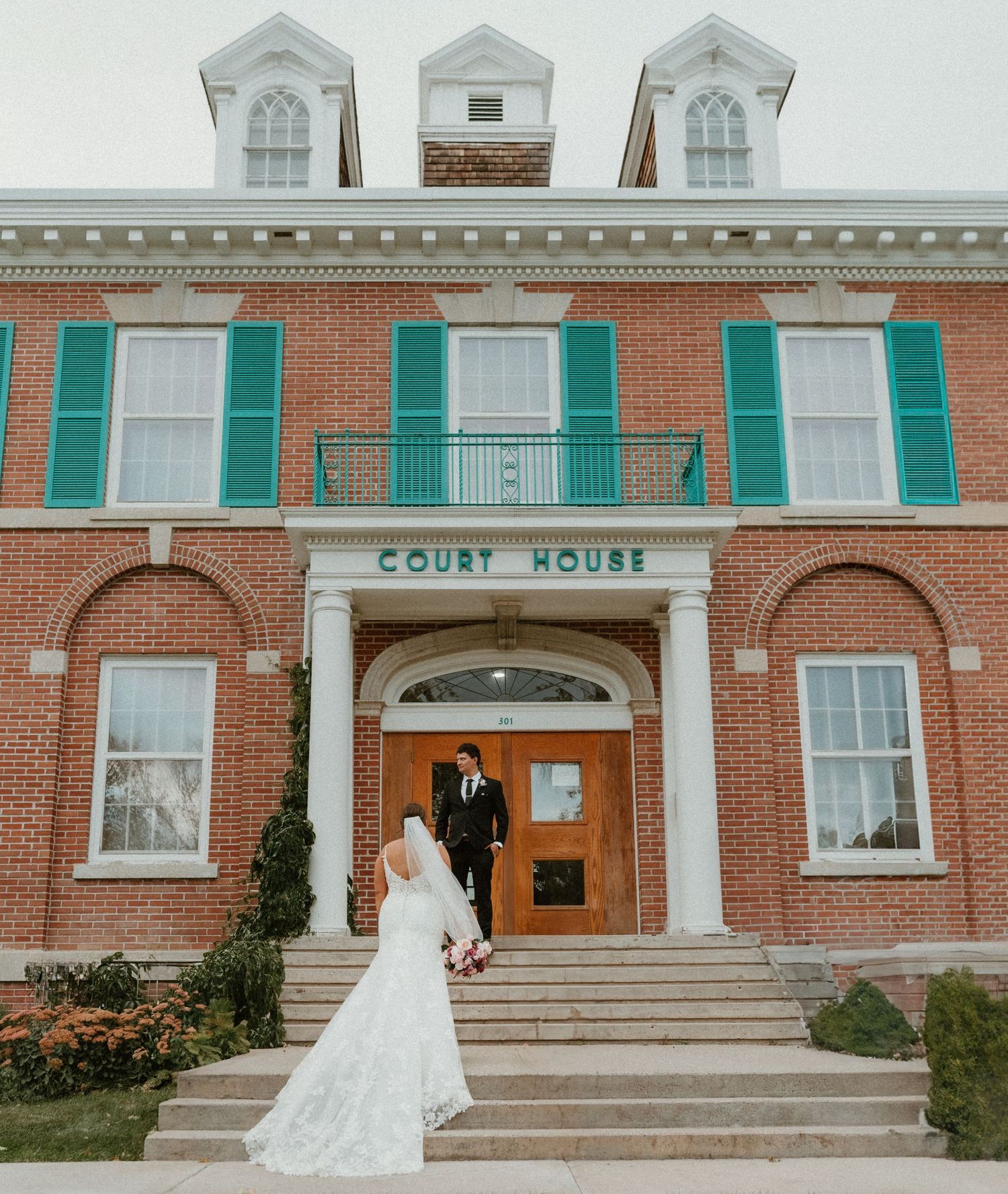 A bride and groom celebrating their intimate elopement at an Okanagan court house wedding.