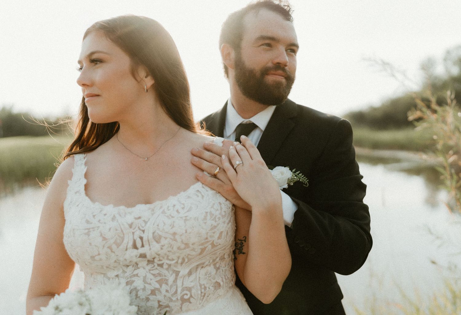 A portrait of a bride and groom on their wedding day during golden hour.
