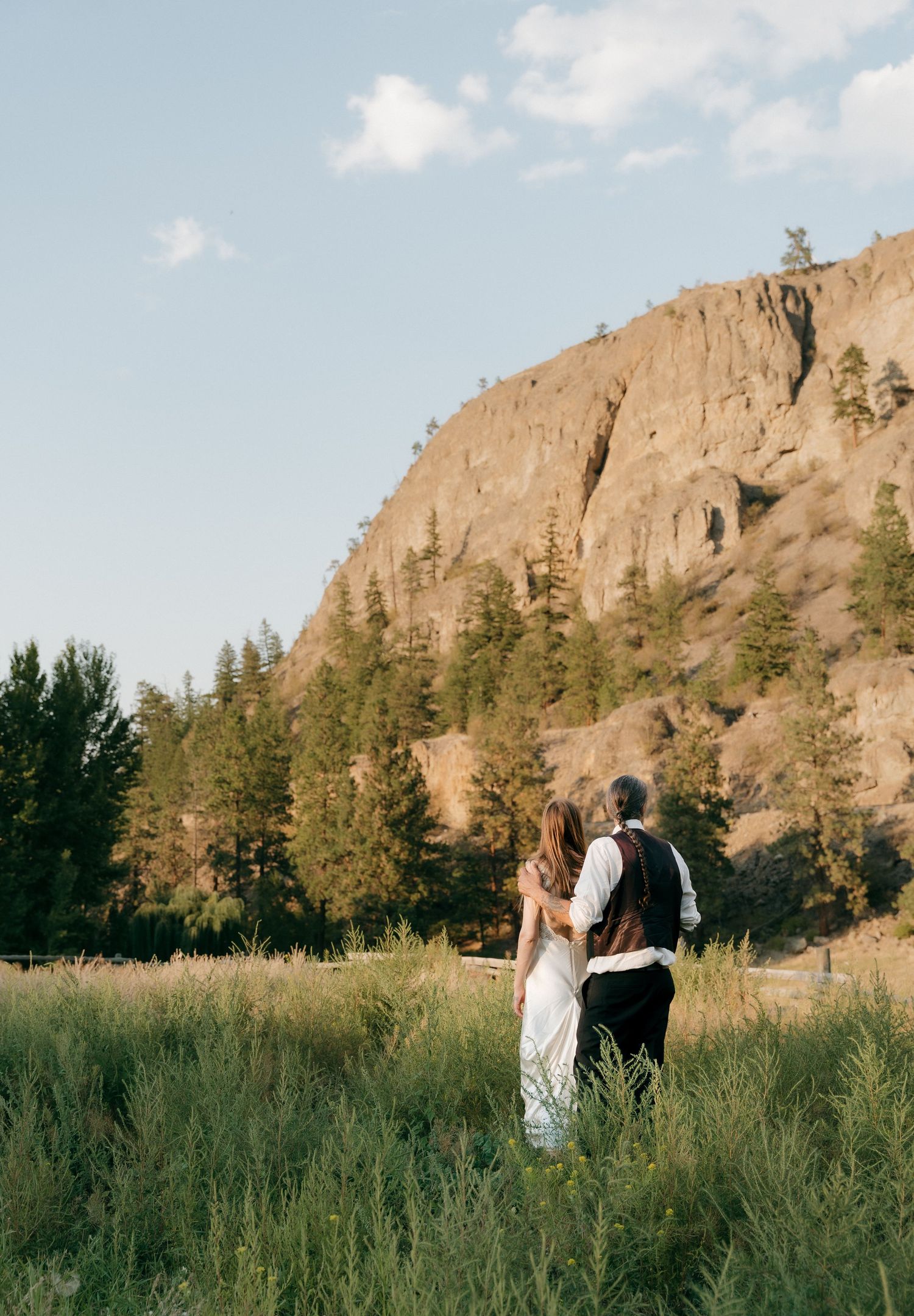 a candid moment of a bride and groom enjoying the mountain scenery at their okanagan elopement.