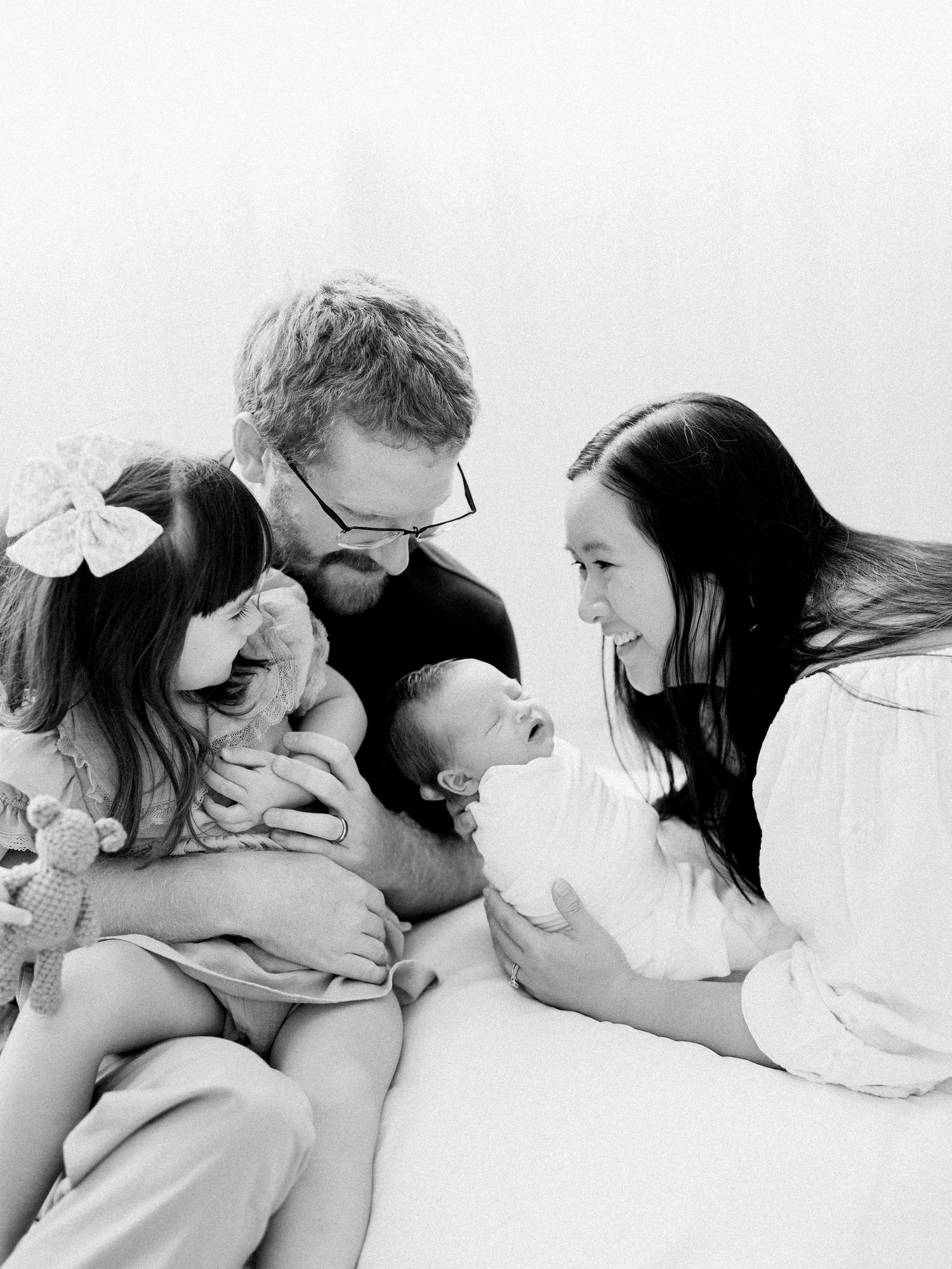 new parents holding newborn daughter in nursery