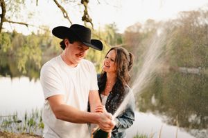 Playful moment captured by the water's edge in natural lighting.