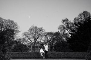 Black and white landscape featuring formal garden hedges and architecture.