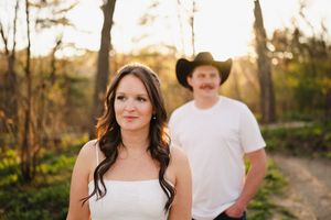 Romantic outdoor portrait session in golden sunlight with rustic country styling.