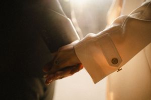 Artistic backlit close-up of couple during intimate moment.