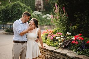 Romantic couple moment among blooming flowers and greenery.