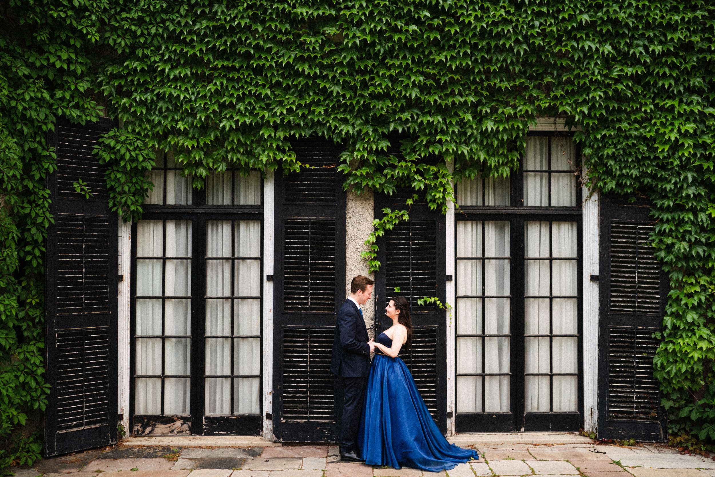 Ivy-covered brick building provides backdrop for formal portraits.