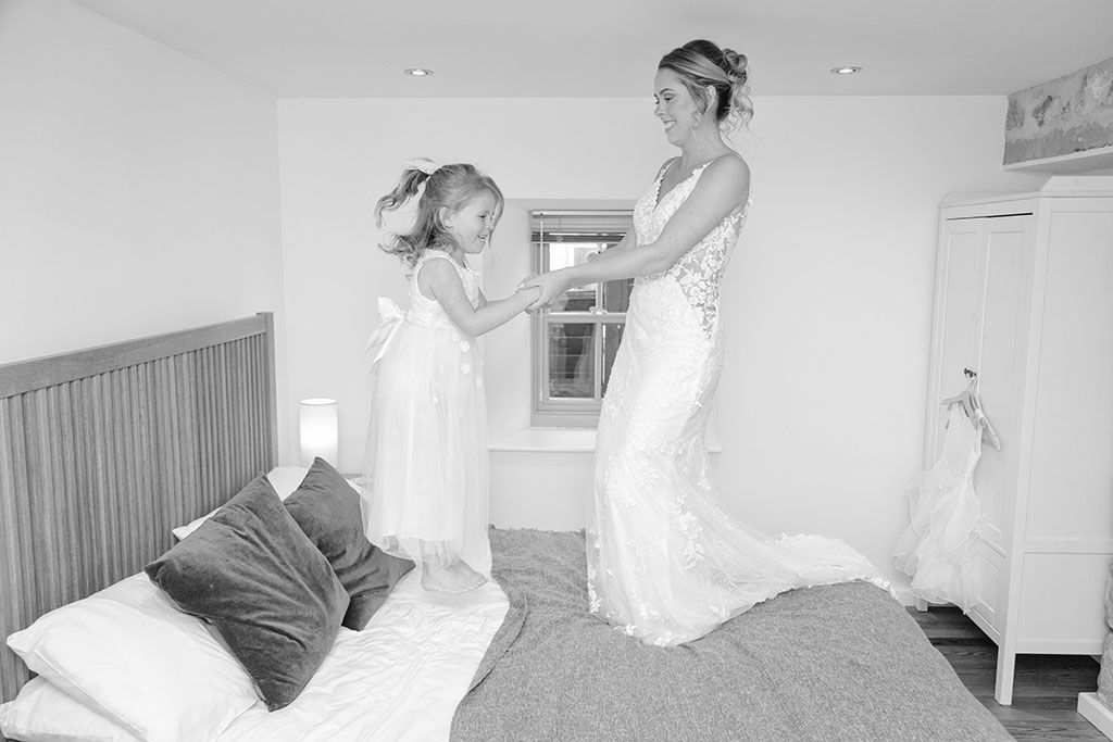 mother and daughter bouncing on the bed