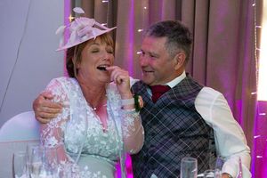 mother and father laughing at the speeches