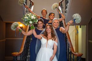 bride and bridesmaids on the stairs