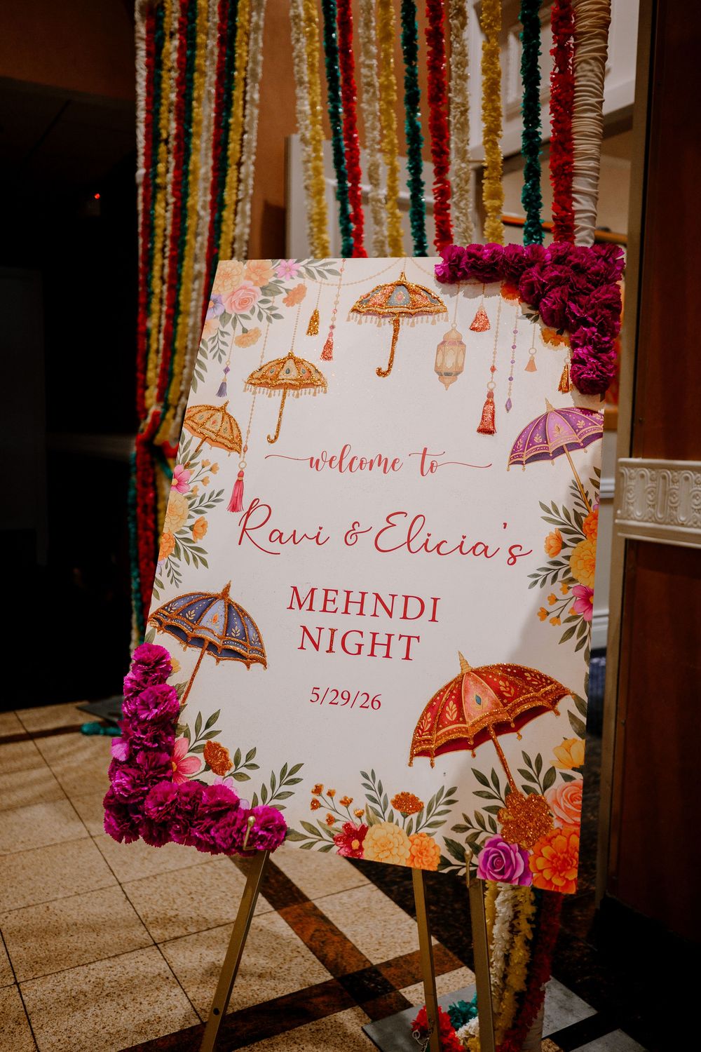 Colorful Mehndi Night welcome sign with umbrella illustrations for Ravi and Elicia's celebration on 5/29/26.