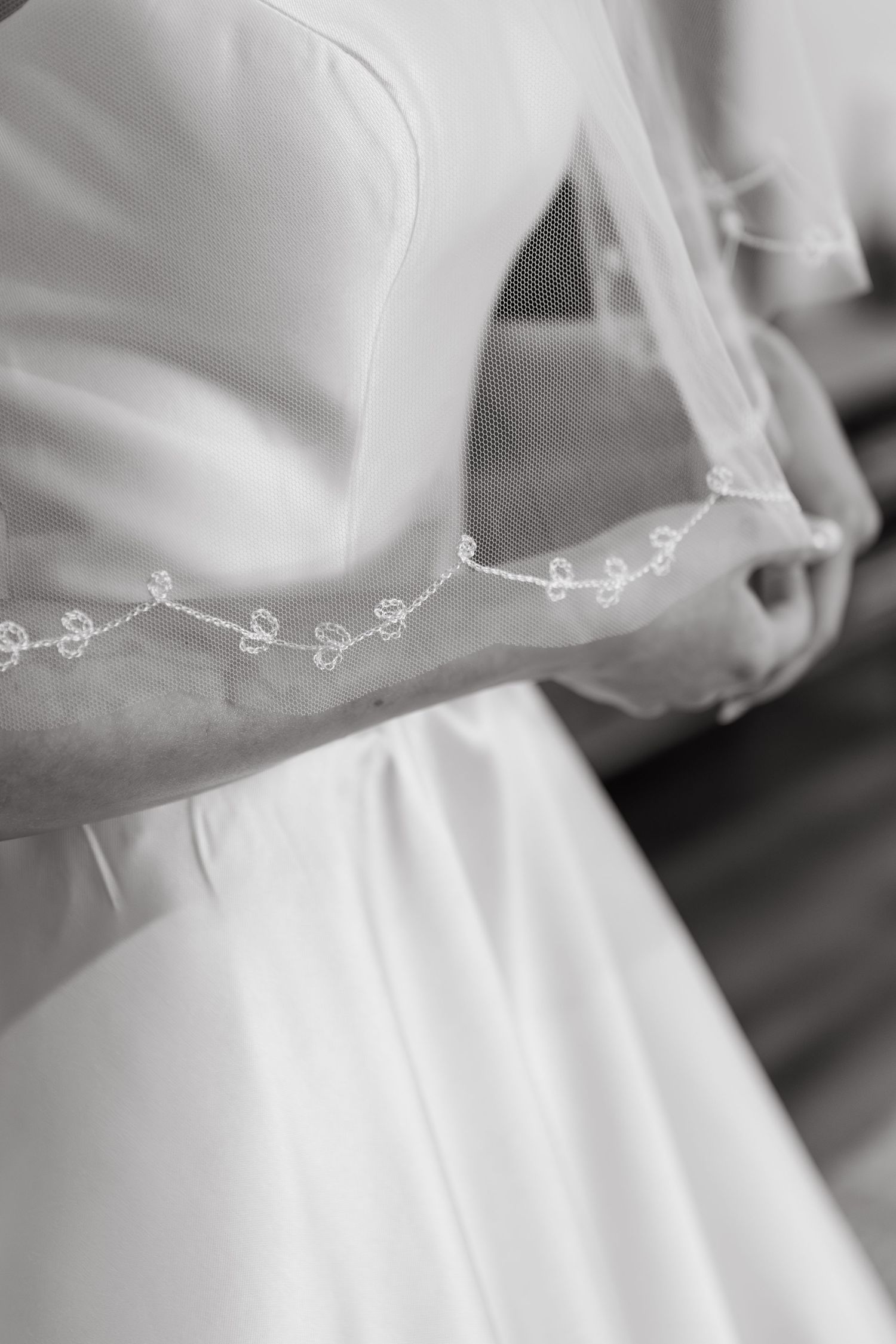 bride in wedding dress and close up of detail on veil in black and white at two rivers wedding
