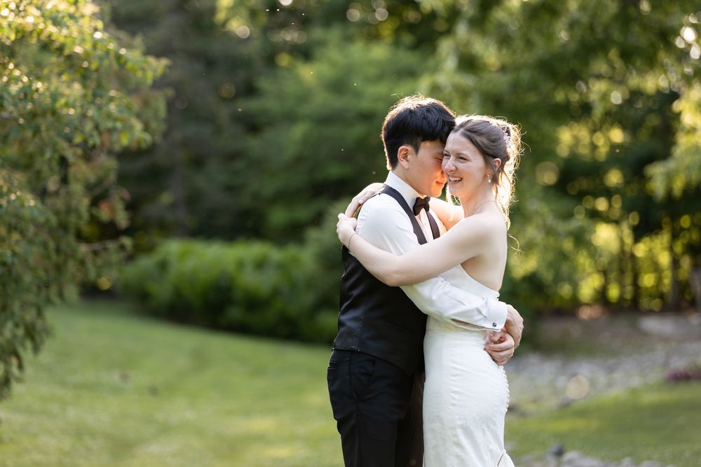 Bride and groom embracing in garden, sharing romantic moment, during sunset at the civic garden complex in london, ontario.