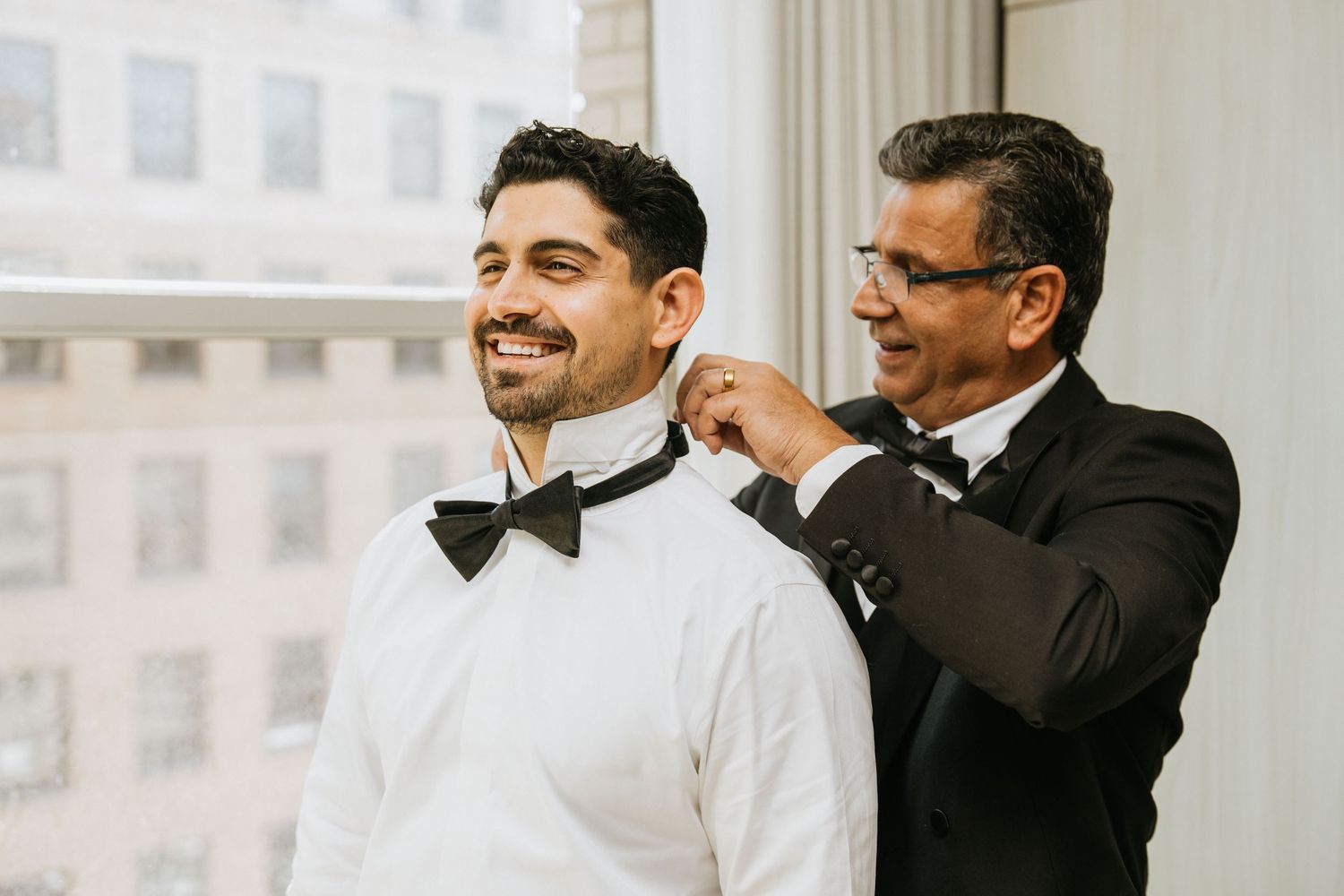 wedding-003
Groom smiling while an his father helps fasten his bow tie before the ceremony.