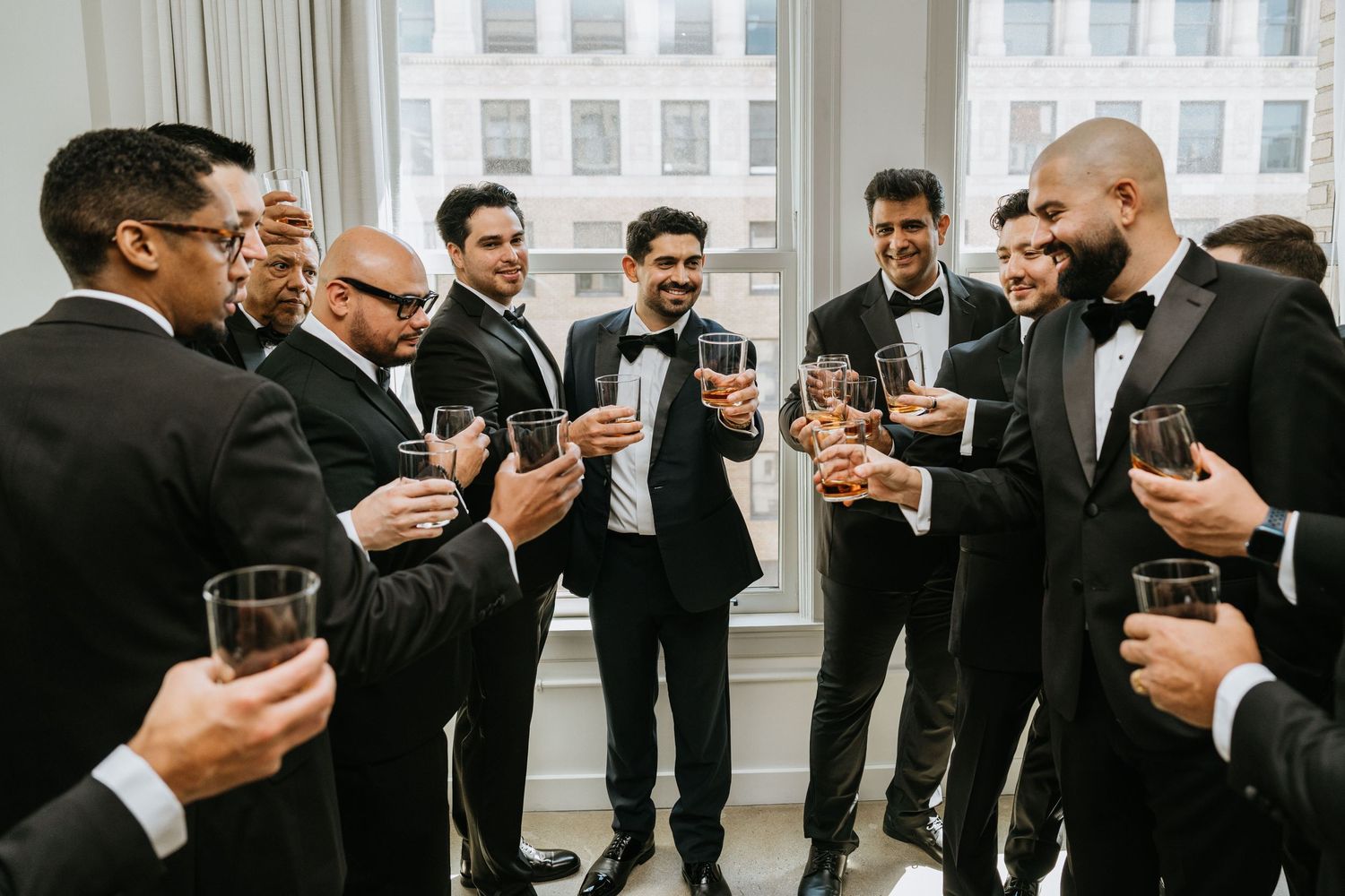 Groomsmen sharing a toast together before the ceremony.