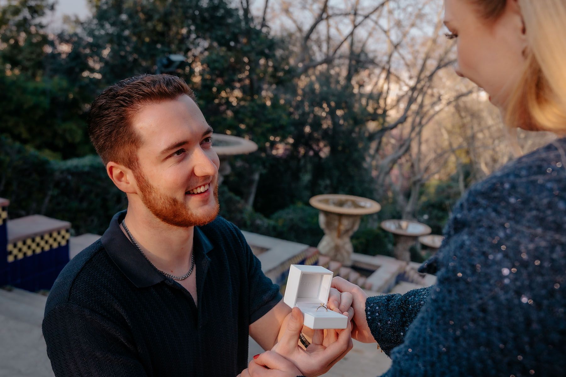 Man proposing to his partner on a private, hidden stairway path at Montjuic fountains away from crowds