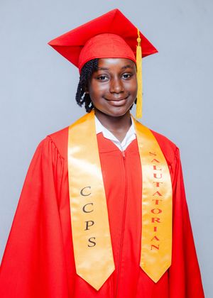 Young female student in red graduation gown and cap wearing CCPS Salutatorian gold stole, smiling proudly.