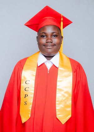 Student in red graduation cap and gown with gold CCPS stole smiling for official graduation portrait.
