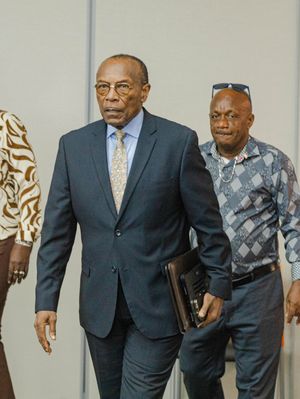 Three men in business attire walking through a modern conference venue.
