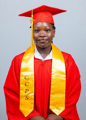 Graduate in red cap and gown with gold CCPS honor stole smiling for graduation portrait photo.