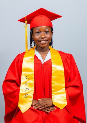 Student smiling in red graduation cap and gown with gold CCPS stole, posing for official graduation portrait.