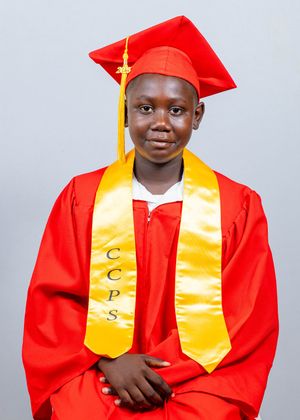 Student wearing red graduation cap and gown with gold CCPS honor stole poses for portrait.