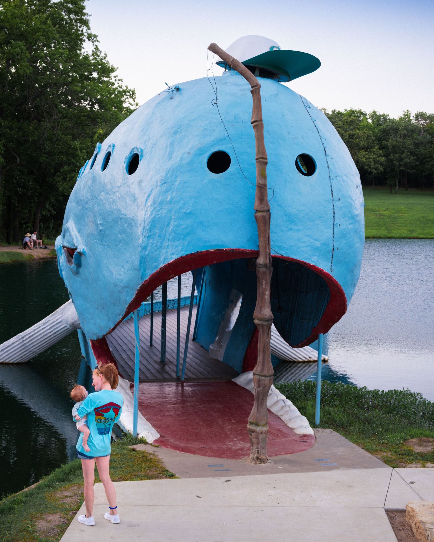 4. A woman smiles at the small child in her arms while standing at the entryway to the whale’s mouth. June 10, 2026.