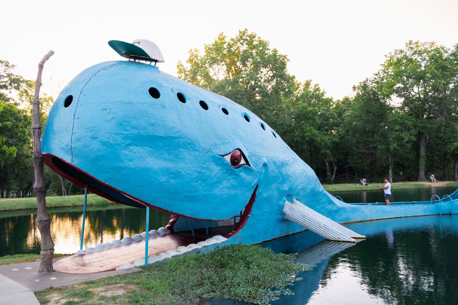 7. A young man is seen fishing from the tail of the Blue Whale of Catoosa. June 10, 2026.