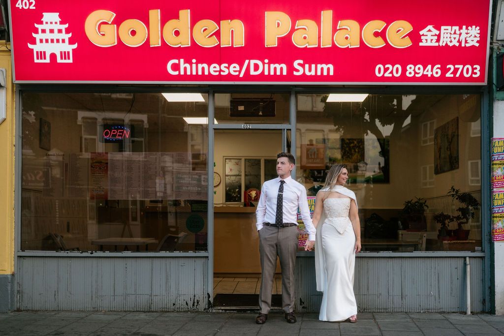 Bride and groom holding hands outside Golden Palace Chinese Dim Sum restaurant in London on their wedding day.